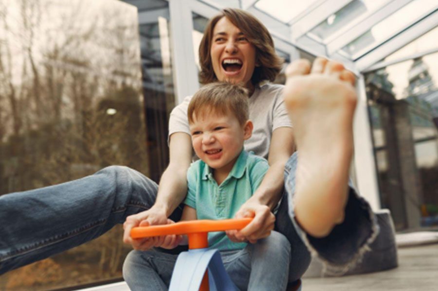 Mother and son riding a toy bike