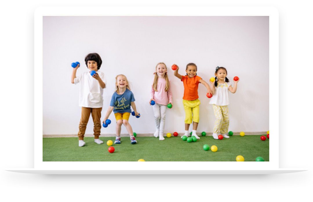 Young boy and girls playing indoors with balls